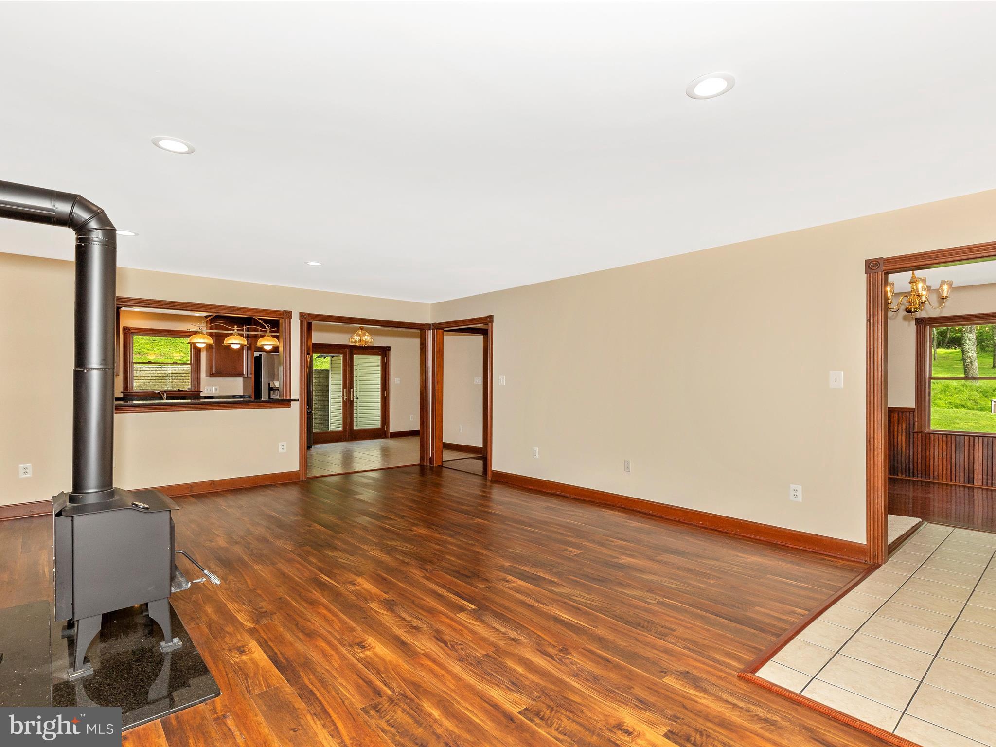 10433 Grindstone Run Road Myersville, MD 21773 - Photo 15 of 42 a view of an empty room with glass door and wooden floor