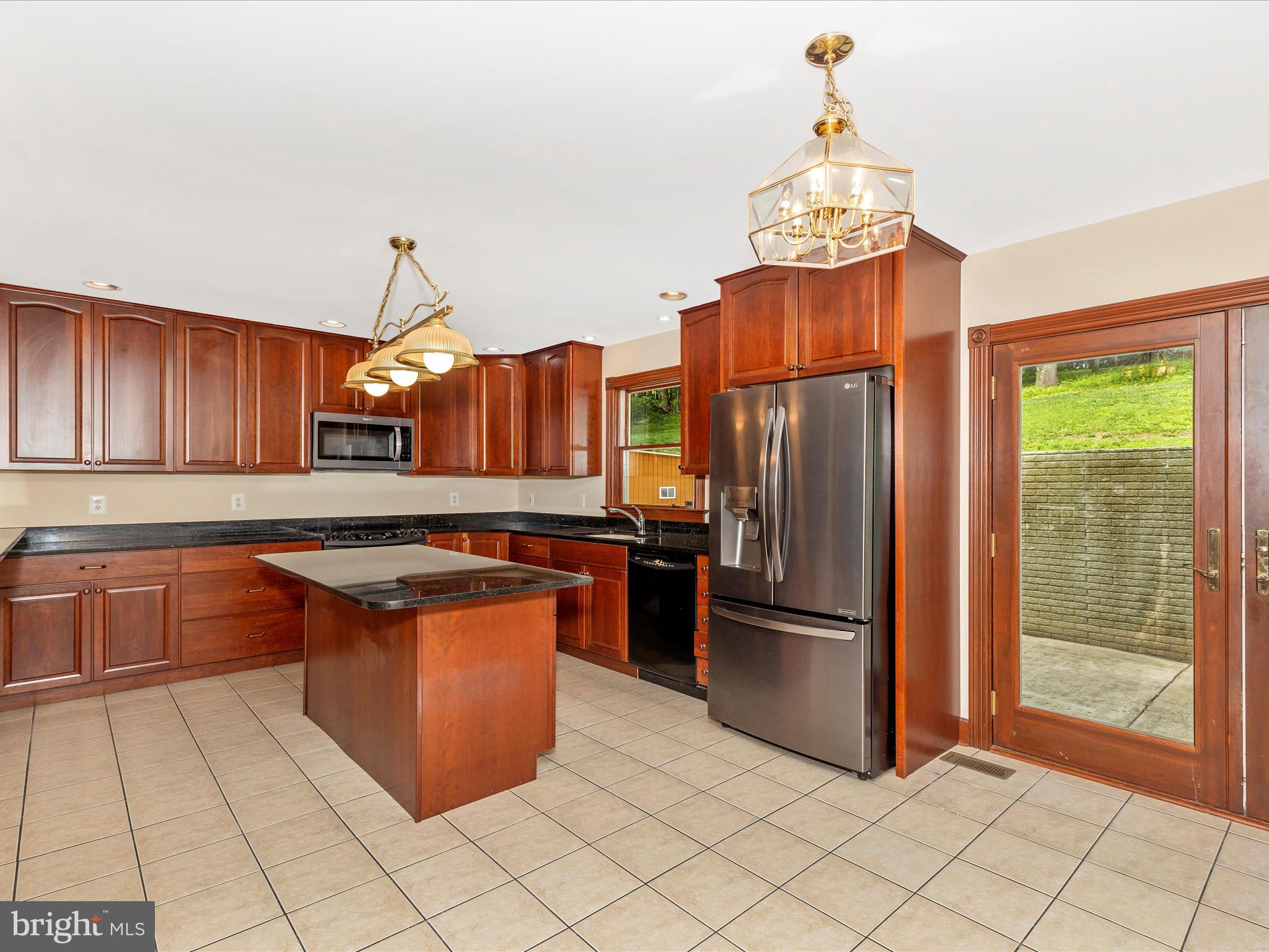 10433 Grindstone Run Road Myersville, MD 21773 - Photo 17 of 42 a kitchen with stainless steel appliances granite countertop a refrigerator a sink and a stove