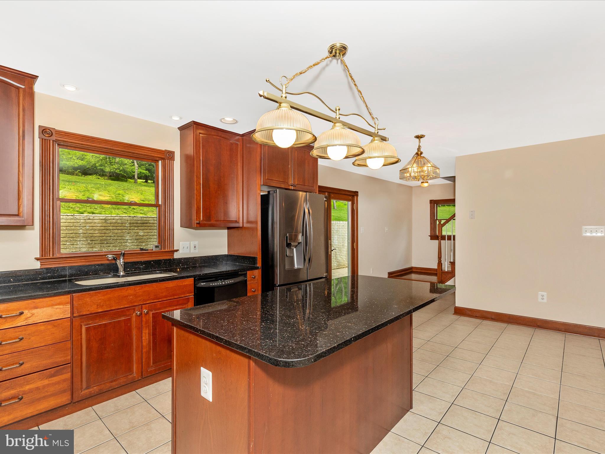10433 Grindstone Run Road Myersville, MD 21773 - Photo 21 of 42 a kitchen with granite countertop a sink a counter space and cabinets
