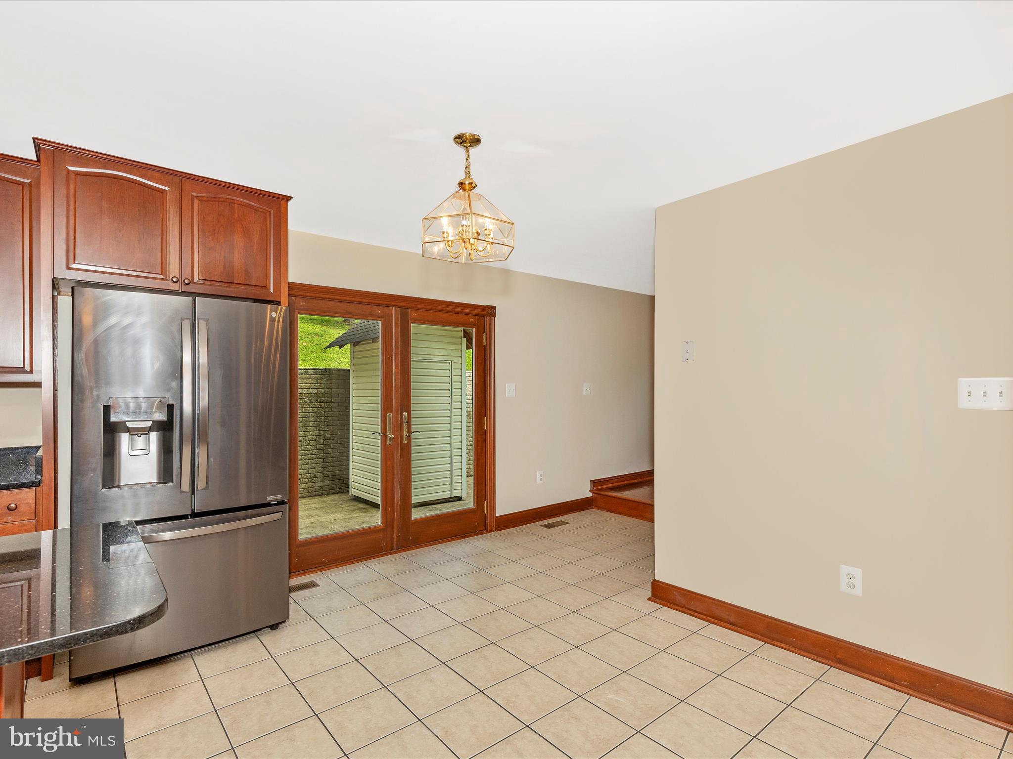 10433 Grindstone Run Road Myersville, MD 21773 - Photo 22 of 42 a view of a refrigerator in kitchen and an empty room