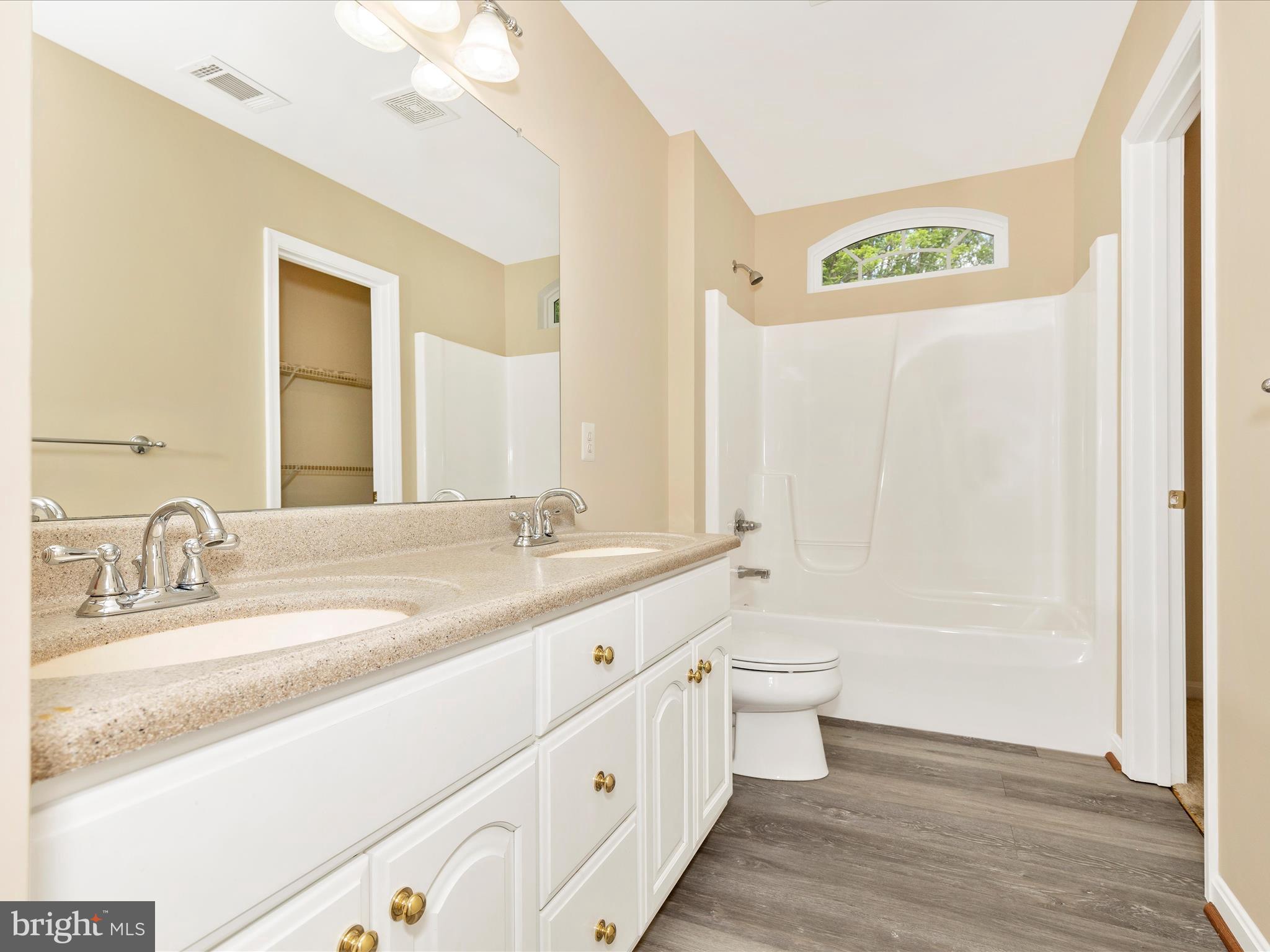 10433 Grindstone Run Road Myersville, MD 21773 - Photo 33 of 42 a bathroom with a granite countertop sink a toilet and a large mirror