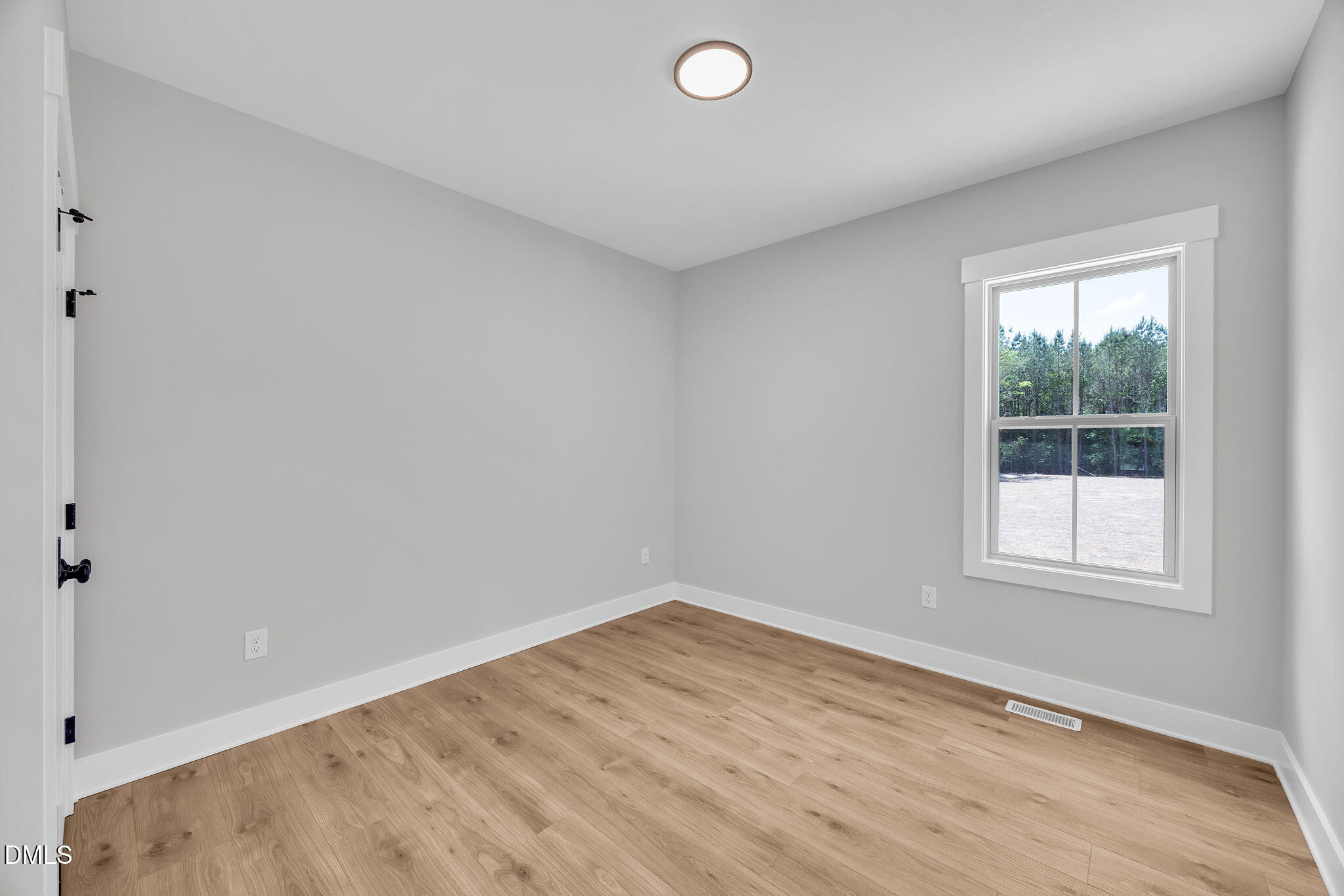 378 Freedom Ridge Drive Smithfield, NC 27577 - Photo 20 of 33 an empty room with wooden floor and windows