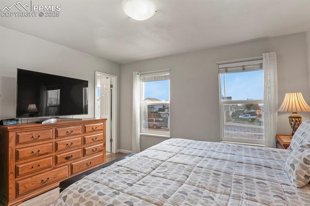 5160 Victory Road Colorado Springs, CO 80911 - Photo 14 of 31 Primary bedroom with two nice windows and an ensuite bathroom