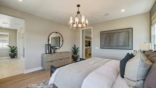 a bedroom with bed and a chandelier