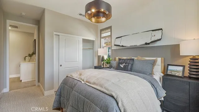 a bedroom with a bed and a chandelier