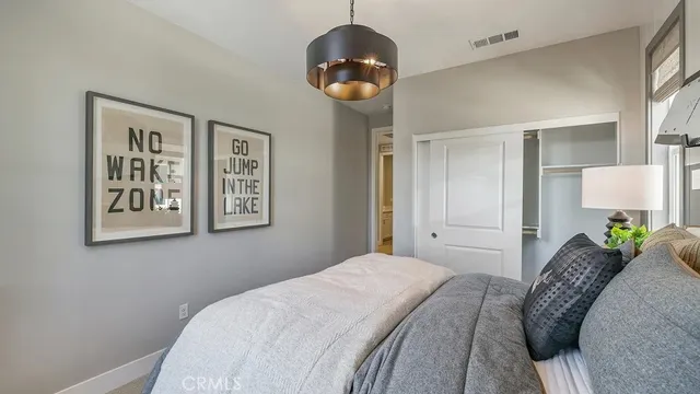 a bedroom with a bed and a chandelier