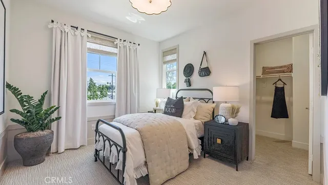 a bed room with a bed and a potted plant