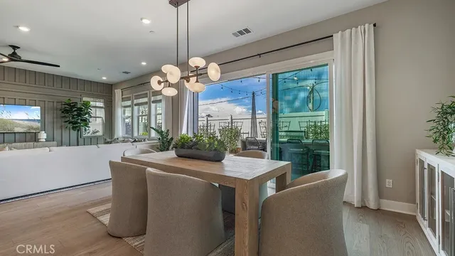 a room with chandelier fan and windows