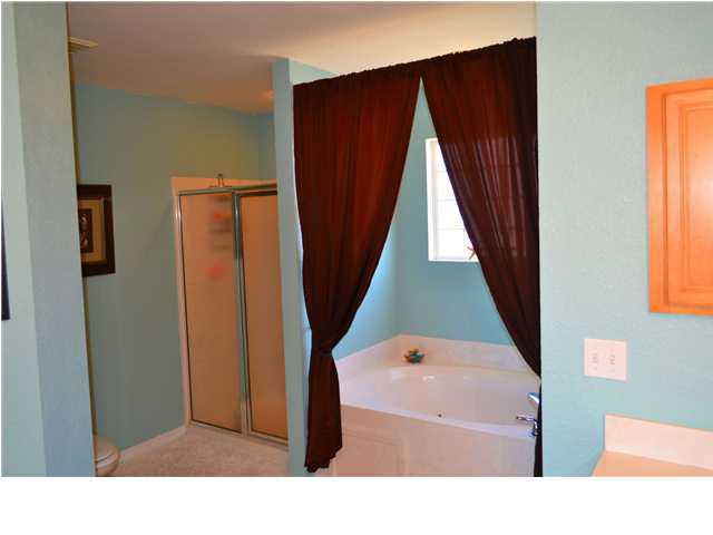 92 Red Bay Court Santa Rosa Beach, FL 32459 - Photo 15 of 19 a bathroom with a sink a mirror and a bathtub
