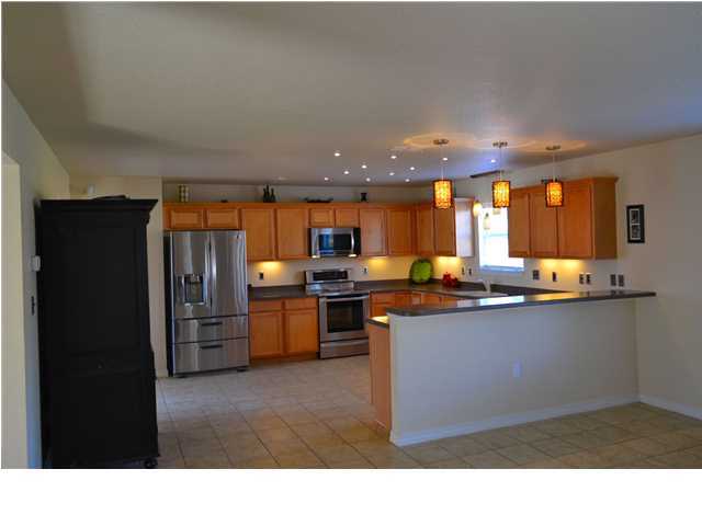 92 Red Bay Court Santa Rosa Beach, FL 32459 - Photo 5 of 19 a kitchen with stainless steel appliances kitchen island granite countertop a refrigerator and cabinets