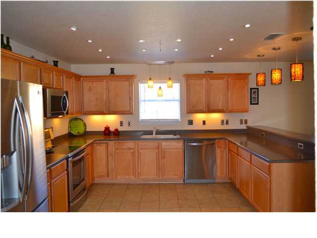 92 Red Bay Court Santa Rosa Beach, FL 32459 - Photo 6 of 19 a kitchen with stainless steel appliances granite countertop a sink stove refrigerator and cabinets