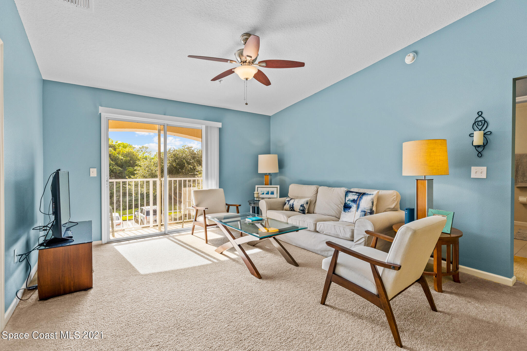 4056 Meander Place, Unit 201 Rockledge, FL 32955 - Photo 14 of 27 a living room with furniture and a lamp