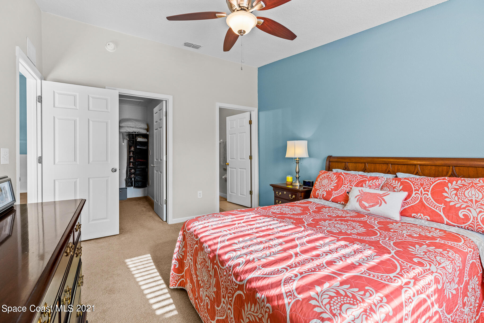 4056 Meander Place, Unit 201 Rockledge, FL 32955 - Photo 18 of 27 a bedroom with a bed and a chandelier