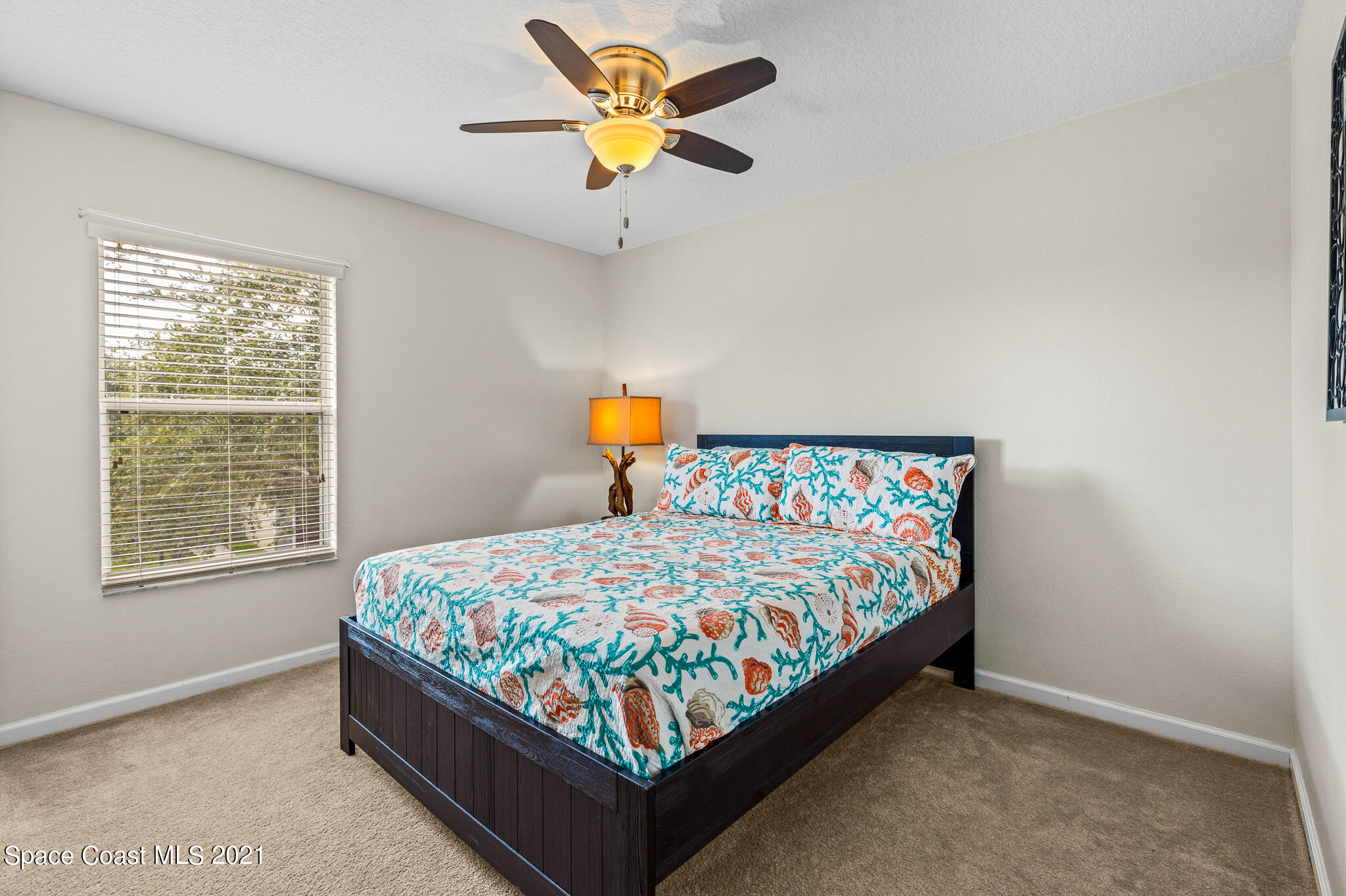 4056 Meander Place, Unit 201 Rockledge, FL 32955 - Photo 6 of 27 a bed sitting in a bedroom next to a window