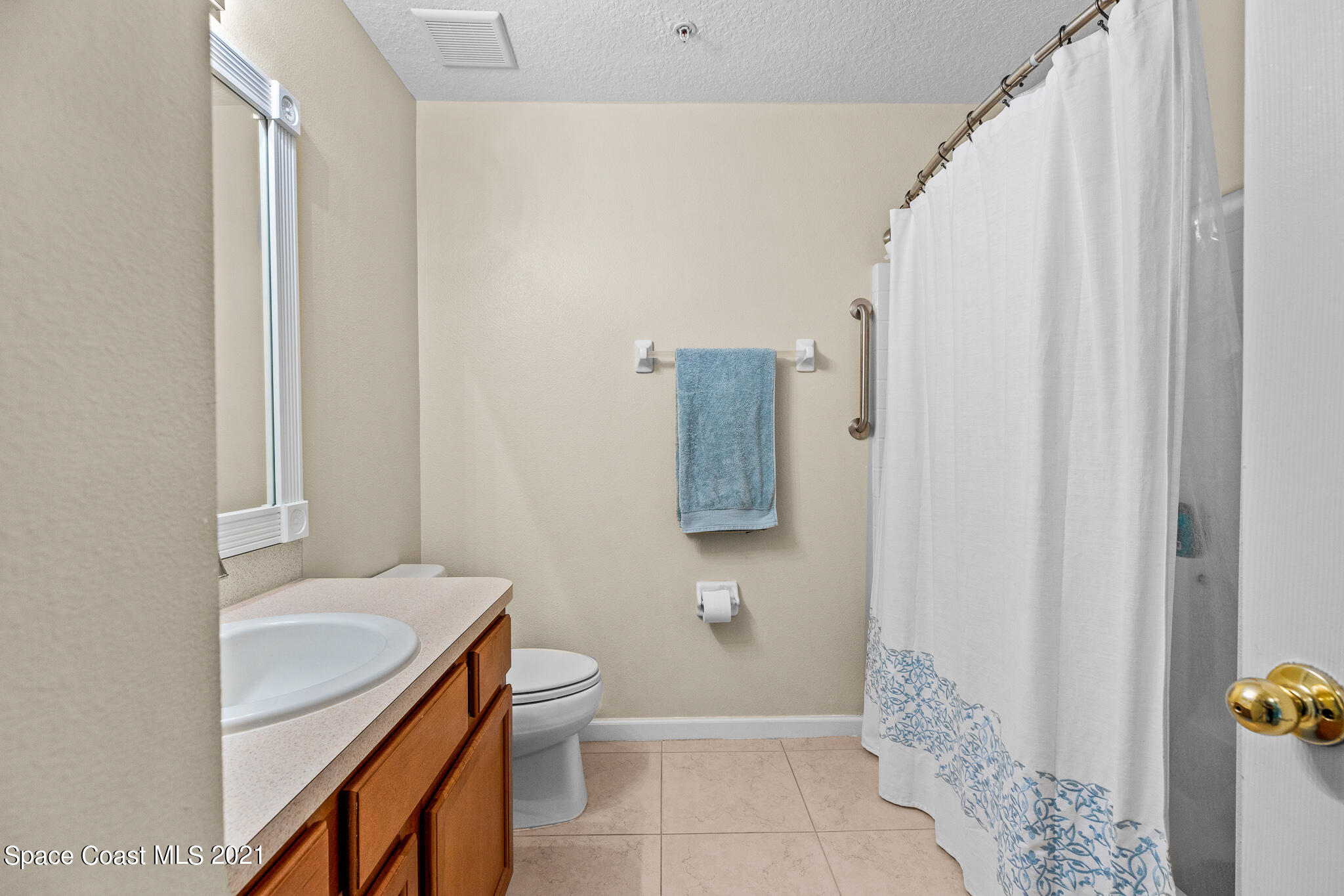 4056 Meander Place, Unit 201 Rockledge, FL 32955 - Photo 7 of 27 a bathroom with a sink toilet and shower