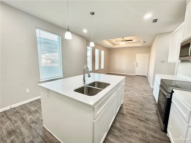 a kitchen with a sink and a refrigerator