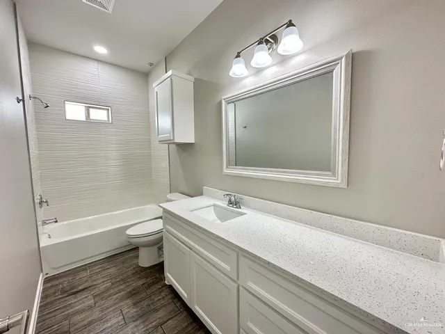 a bathroom with a sink a toilet and bathtub