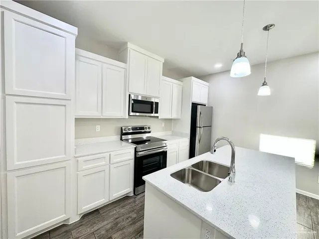 a kitchen with white cabinets and white appliances
