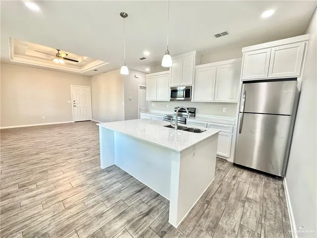 a kitchen with a sink appliances and cabinets