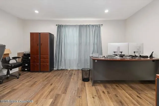 a room with wooden floor and furniture