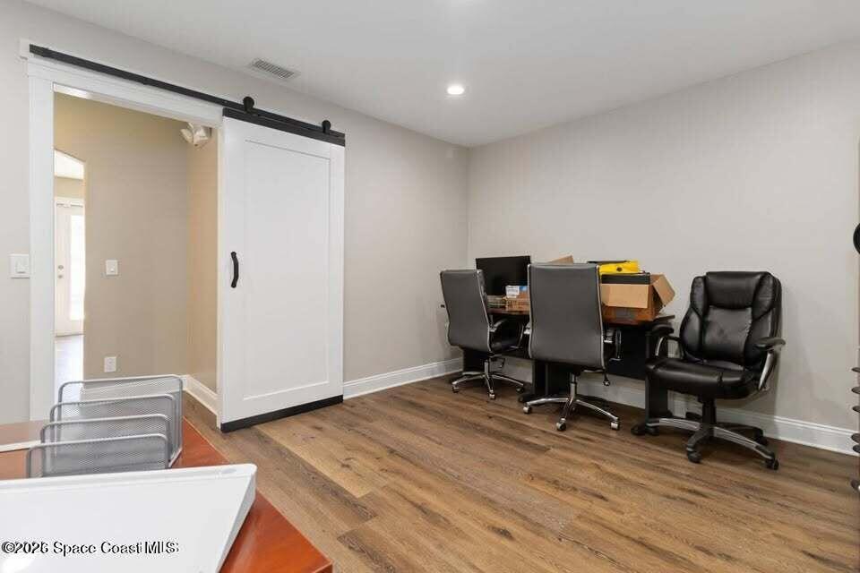 1280 Highway 1, Unit A Malabar, FL 32950 - Photo 14 of 20 a workspace with furniture and wooden floor