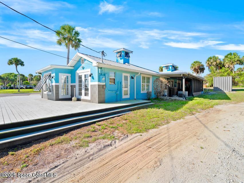 1280 Highway 1, Unit A Malabar, FL 32950 - Photo 24 of 26 a front view of house with a garden and swimming pool