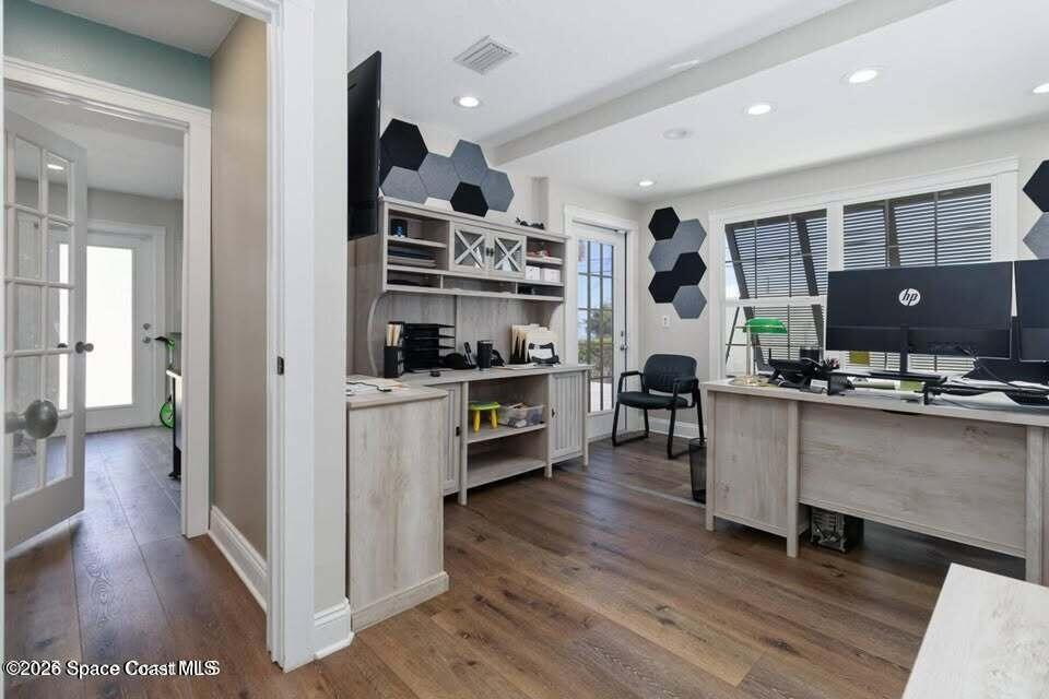 1280 Highway 1, Unit A Malabar, FL 32950 - Photo 10 of 20 a kitchen with stainless steel appliances kitchen island granite countertop a refrigerator a stove and a wooden floors
