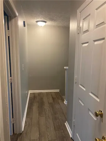 a view of hallway with wooden floor