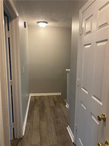 a view of hallway with wooden floor