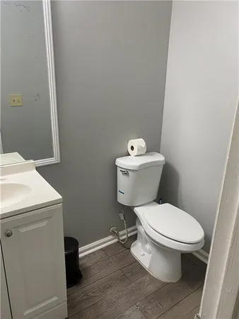 a white toilet sitting next to a white cabinet