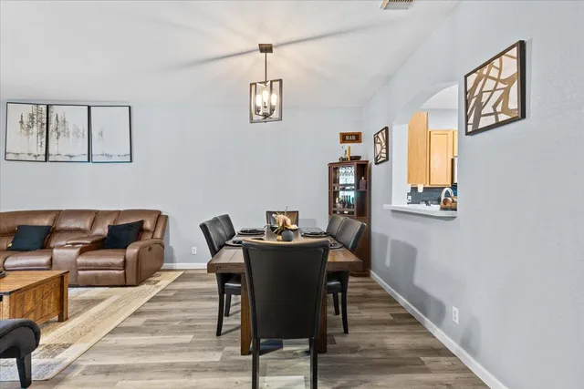 a view of a dining room with furniture wooden floor and a rug