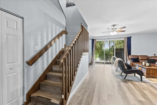 a view of a livingroom with furniture staircase and front door