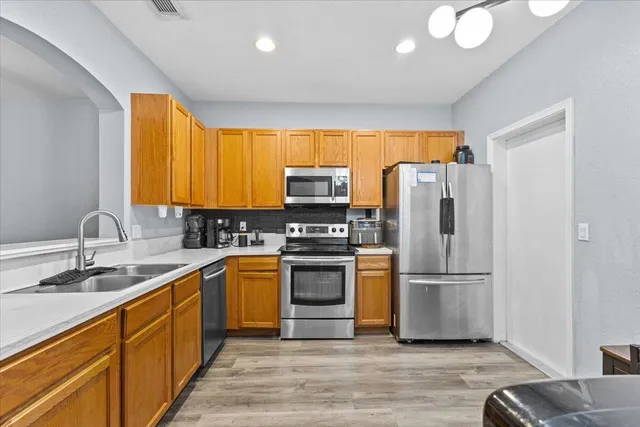 a kitchen with a sink appliances and cabinets