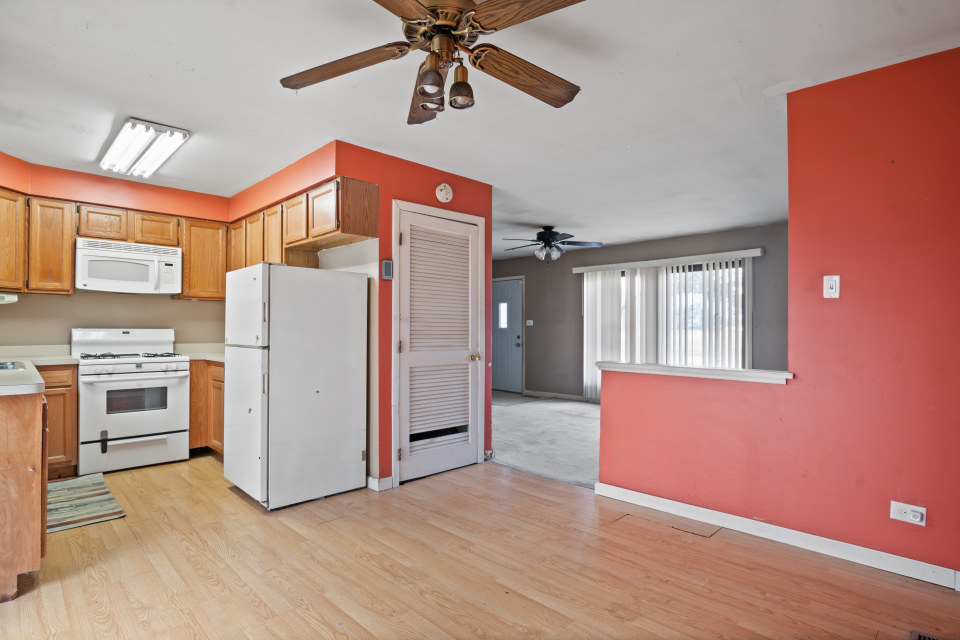 531 Silverleaf Boulevard Carol Stream, IL 60188 - Photo 11 of 25 a view of a kitchen with a refrigerator a microwave and a ceiling fan