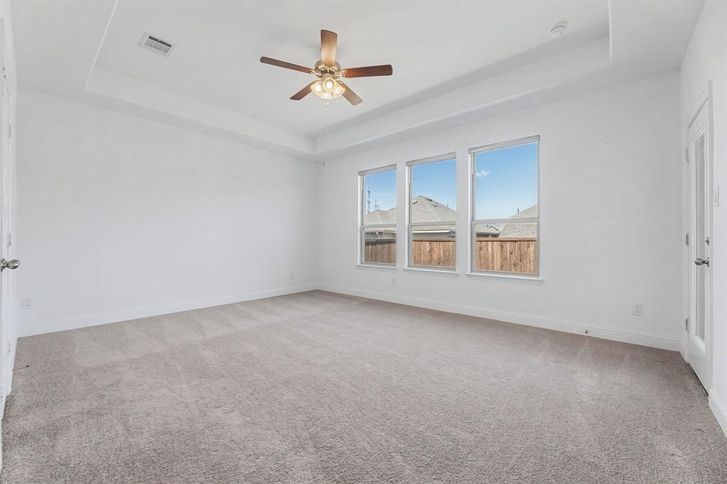 3120 Stonelake Ridge Lewisville, TX 75010 - Photo 12 of 40 an empty room with windows and ceiling fan