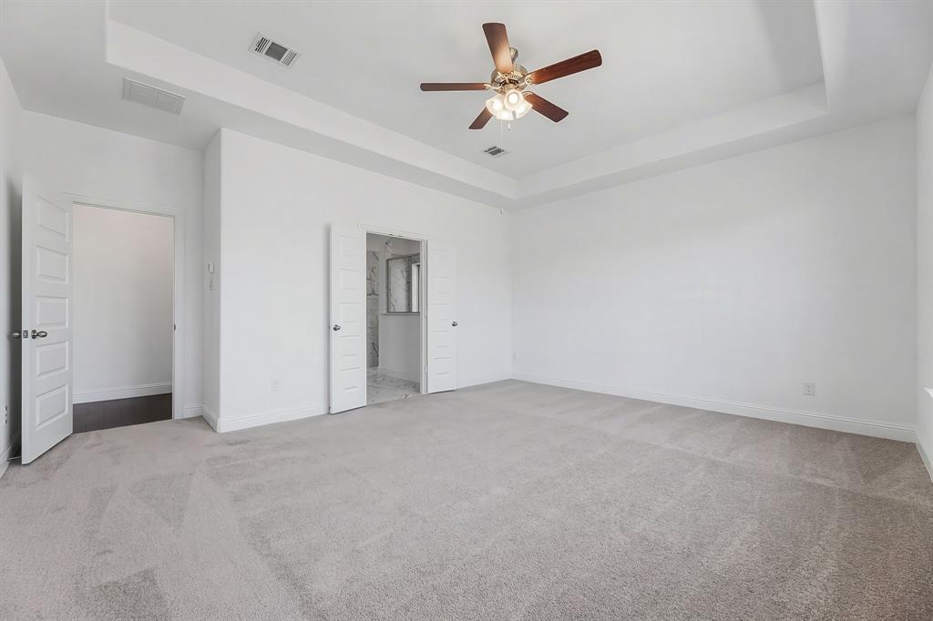3120 Stonelake Ridge Lewisville, TX 75010 - Photo 13 of 40 an empty room with a ceiling fan and a window