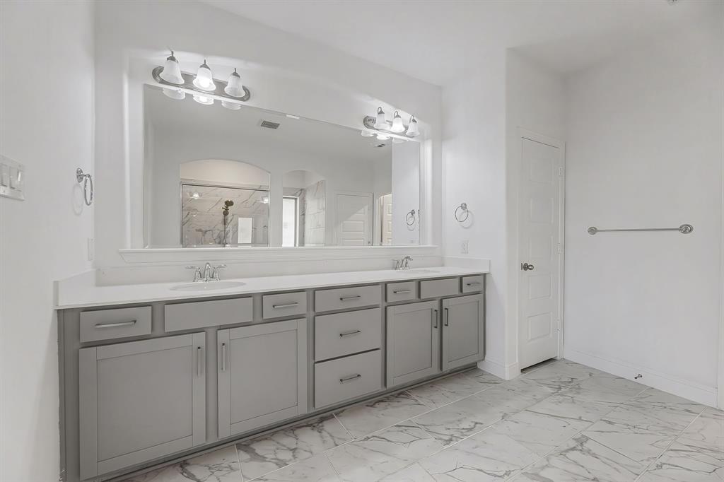 3120 Stonelake Ridge Lewisville, TX 75010 - Photo 16 of 40 a spacious bathroom with a granite countertop sink a mirror and a
