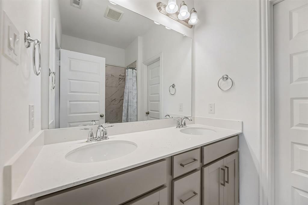3120 Stonelake Ridge Lewisville, TX 75010 - Photo 26 of 40 a bathroom with a sink double vanity and a mirror