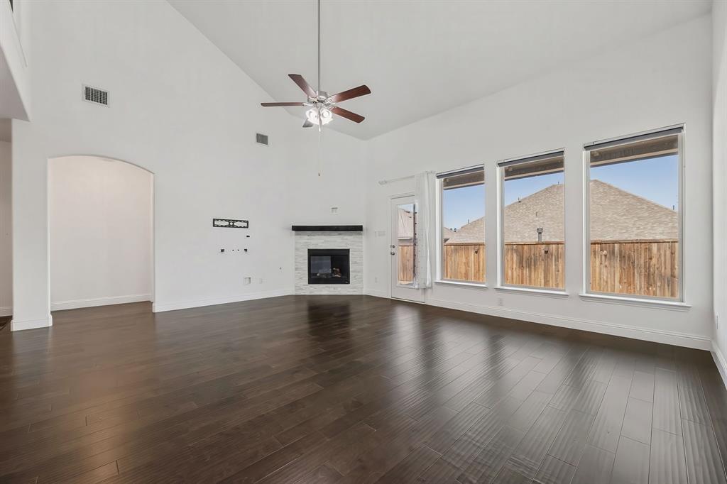 3120 Stonelake Ridge Lewisville, TX 75010 - Photo 3 of 40 a view of an empty room with wooden floor and a window