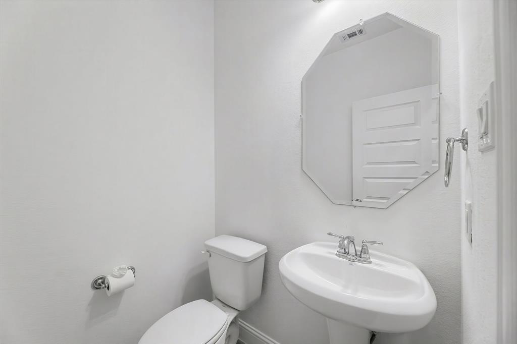 3120 Stonelake Ridge Lewisville, TX 75010 - Photo 30 of 40 a bathroom with a sink toilet and mirror