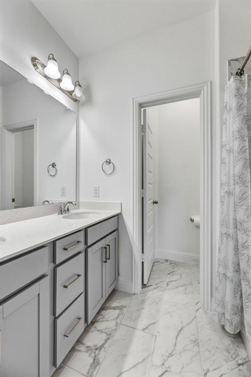 3120 Stonelake Ridge Lewisville, TX 75010 - Photo 31 of 40 a spacious bathroom with a granite countertop sink a mirror and a shower