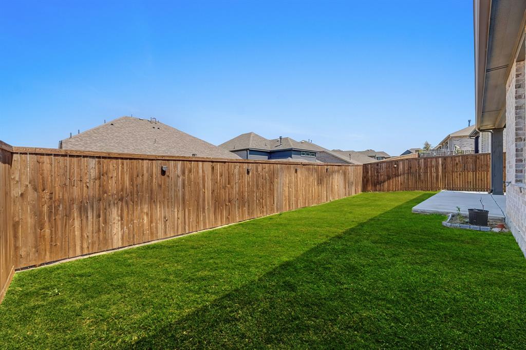 3120 Stonelake Ridge Lewisville, TX 75010 - Photo 39 of 40 a view of a backyard with a garden and wooden fence