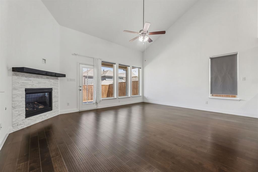 3120 Stonelake Ridge Lewisville, TX 75010 - Photo 4 of 40 a view of an empty room with wooden floor fireplace and a window