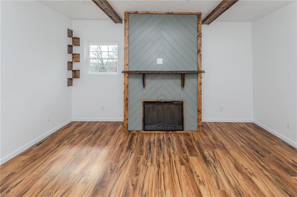 325 Laughlin Street Dawson, PA 15428 - Photo 17 of 34 a room with a bed and a fireplace