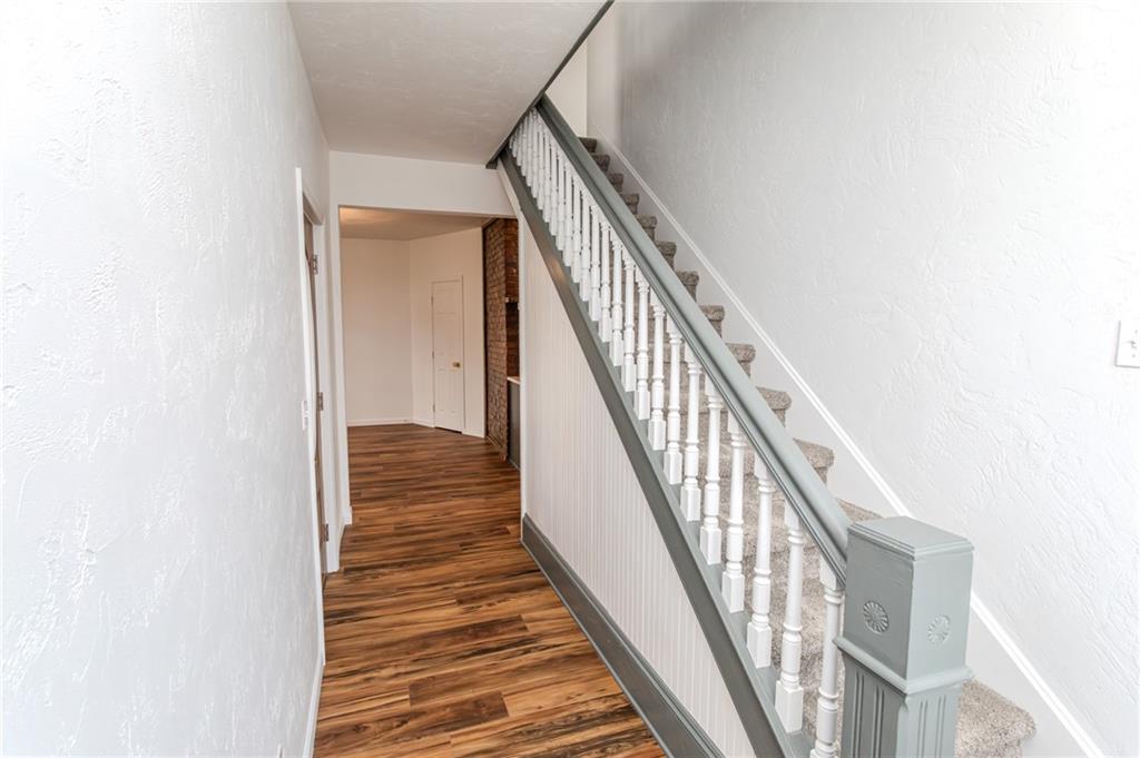 325 Laughlin Street Dawson, PA 15428 - Photo 20 of 34 a view of a hallway with wooden floor and staircase