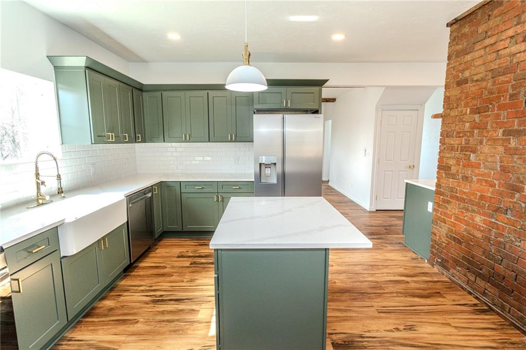 325 Laughlin Street Dawson, PA 15428 - Photo 8 of 34 a kitchen with kitchen island a sink stainless steel appliances and cabinets