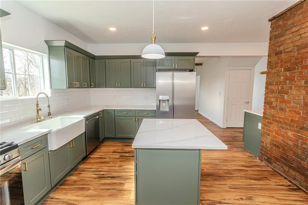 325 Laughlin Street Dawson, PA 15428 - Photo 10 of 34 a large kitchen with granite countertop a sink a counter space stainless steel appliances and cabinets