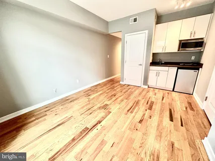a bedroom with a bed and a black white wall