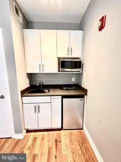 a kitchen with a stove and a white cabinet