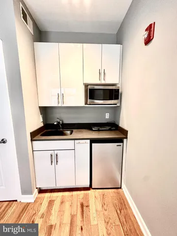a kitchen with a stove and a white cabinet